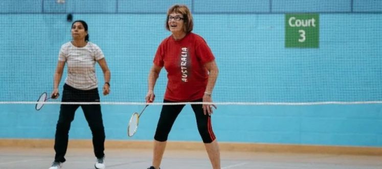 An image of two women playing doubles/pairs badminton