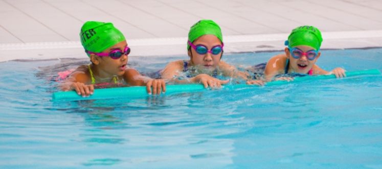 Children taking part in a development swimming lesson