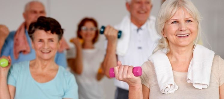 An image of some senior members using dumbbells in a fitness class