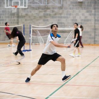 Teenagers playing badminton