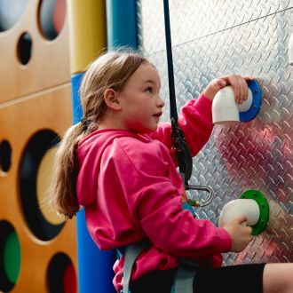 young girl on a climbing wall young girl on a climbing wall
