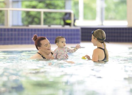 family playing in a pool