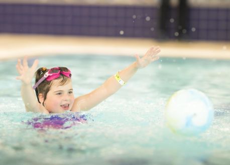 young girl playing in a pool