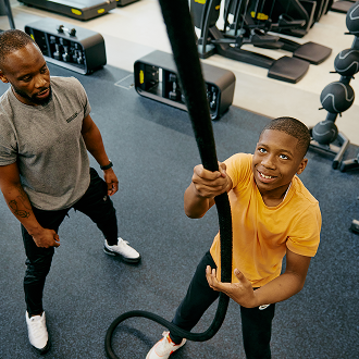 A man and child working out at an Adult and Junior gym session A man and child working out at an Adult and Junior gym session