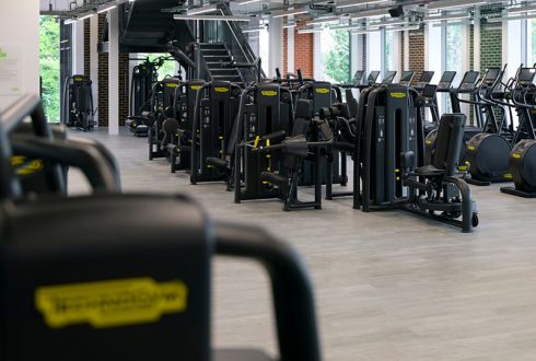 resistance leg machine in a bright open gym