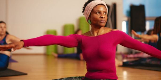 A woman doing yoga in a fitness studio