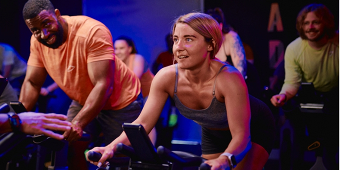 People working out in a group cycle class in Bedfordshire