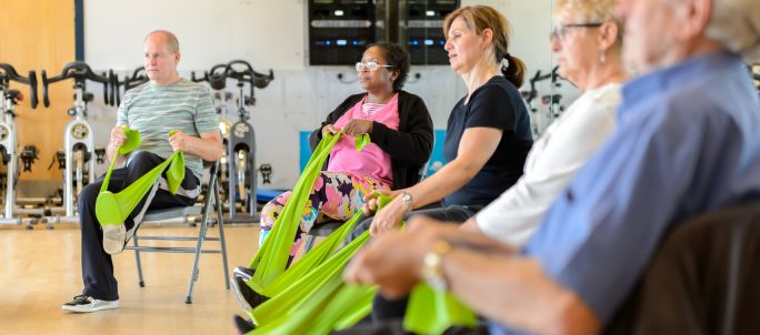 seniors in a seated exercise class