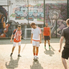 Men playing football outdoors 