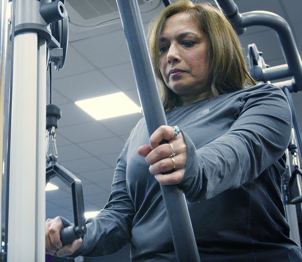 A female member using a gym equipment