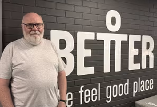 Pete standing in front a sign at the gym