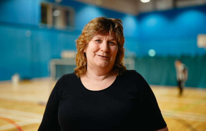 Woman in a sports hall wearing a black t-shirt Woman in a sports hall wearing a black t-shirt