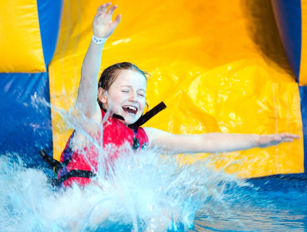 girl coming down slide of inflatable girl coming down slide of inflatable