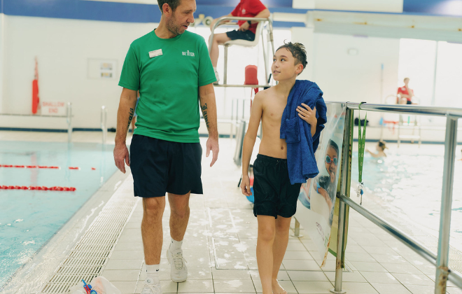 Swiim school teacher and student walking poolside