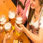 People in Traditional Bavarian Clothing Drinking Beer