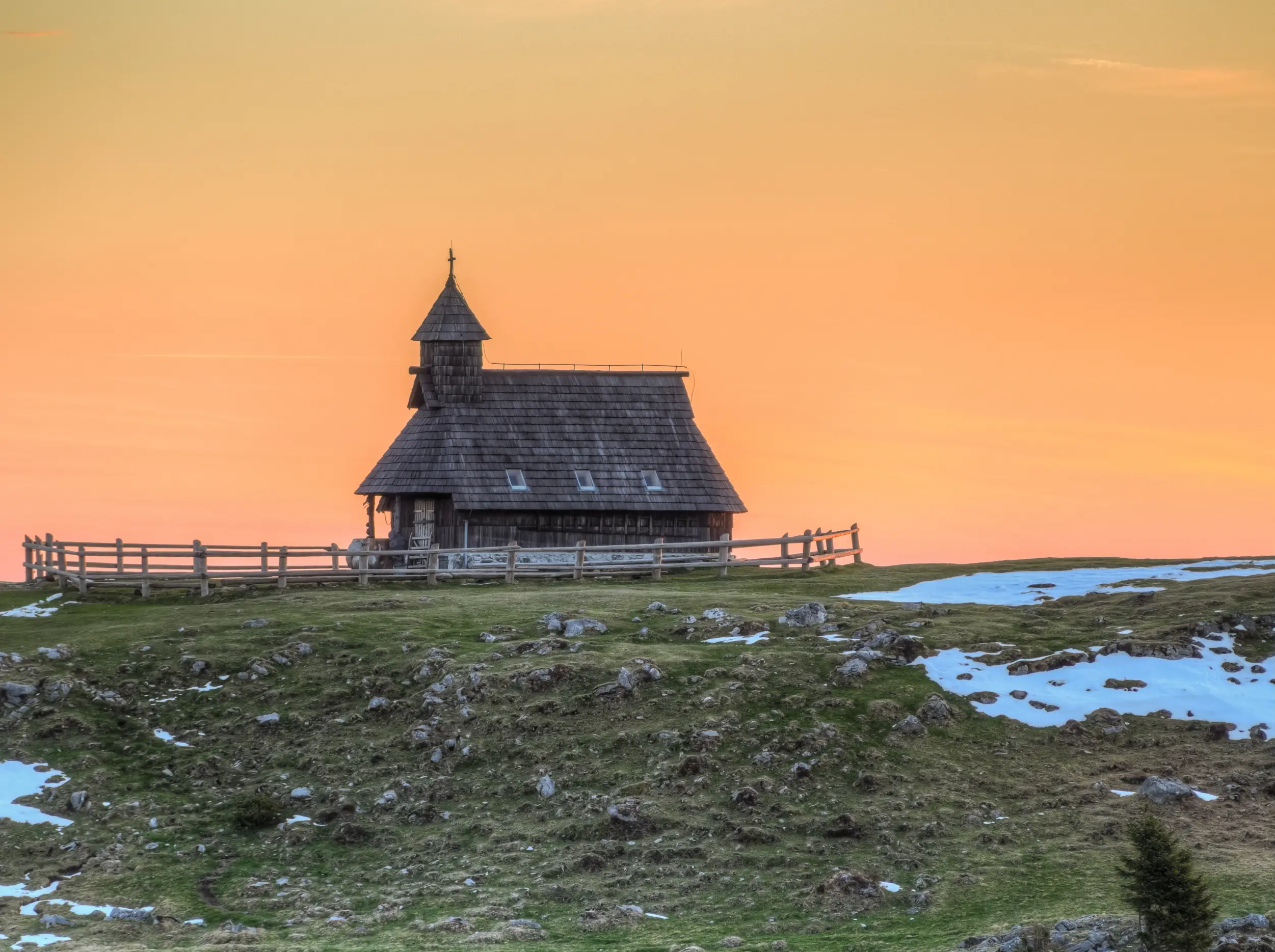 An Old Wooden Hut in a Snowy Field