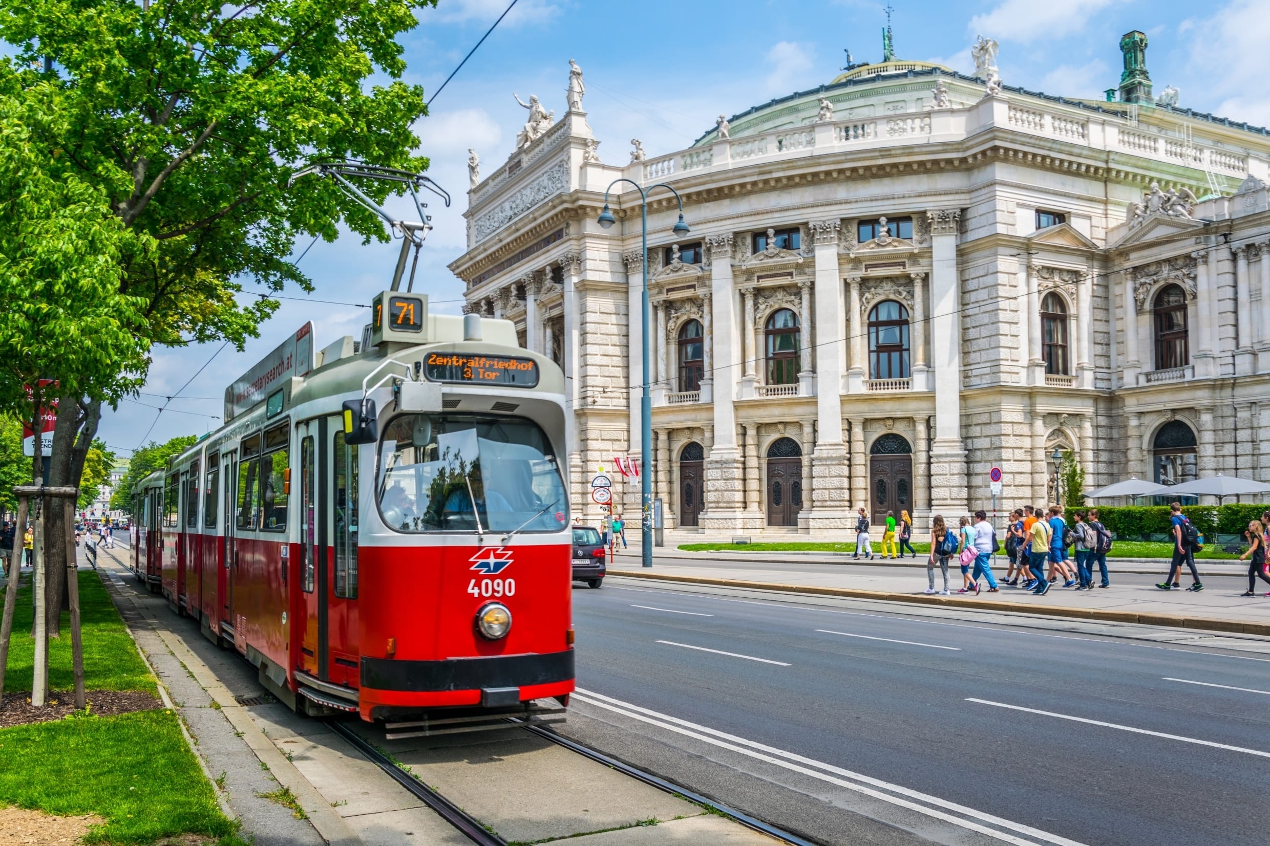 Red Tram Moving Along Ring Street in Front of City Hall