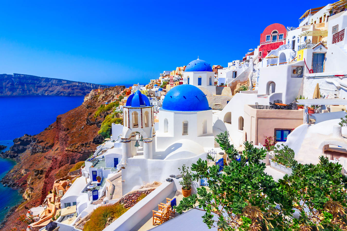 Blue domes of Oia Santorini and white washed buildings