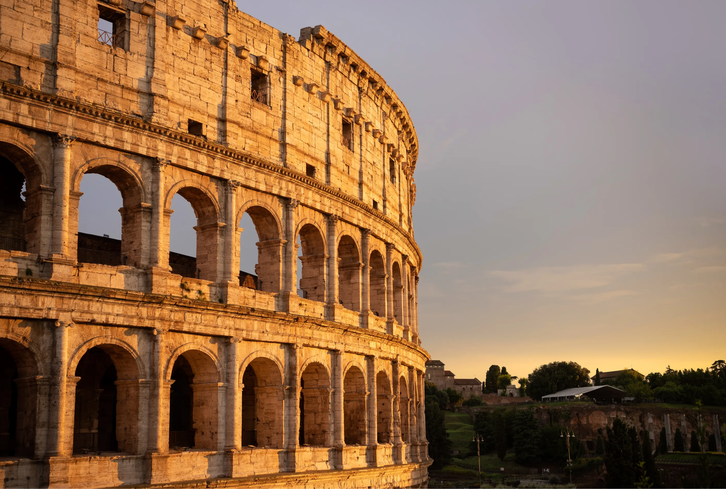 sunset over colosseum in rome italy