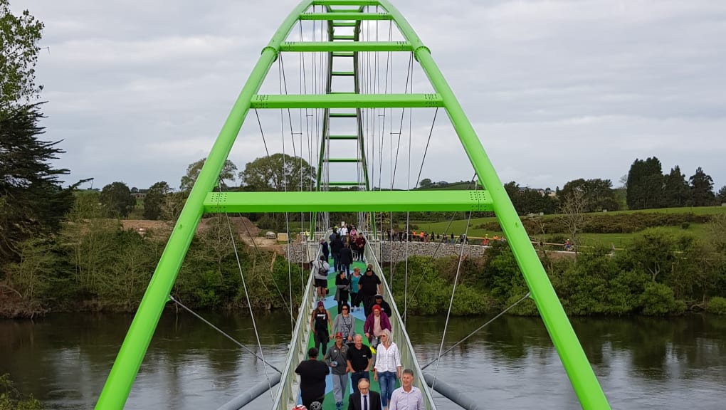 View of people walking over the Perry Bridge