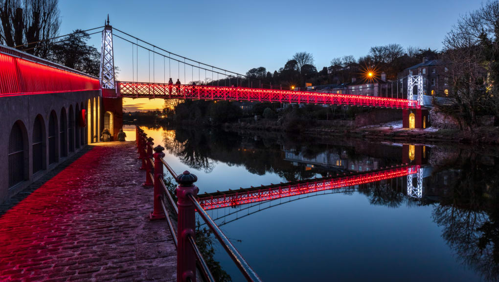 Night time view of the side of the Daly bridge at sunset