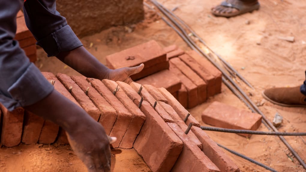 Bricks used in the construction of Collège Hampaté Bâ laid out in rows. Copyright: Grant Smith