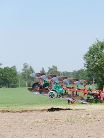 Packers - Kverneland Packomat compact and transported above ground level, dragged by tractor in a folded shape