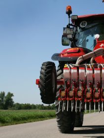 Kverneland Miniair Nova transported on road by tractor