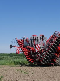 Kverneland U-drill, transported on road by tractor