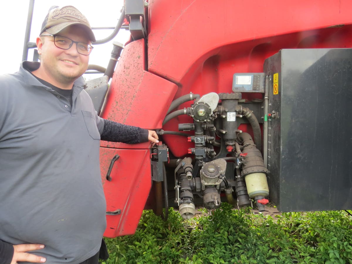 Simon Bækgaard Christensen showing the hydraulic controls and filling system on the Kverneland iXtrack T6 sprayer.
