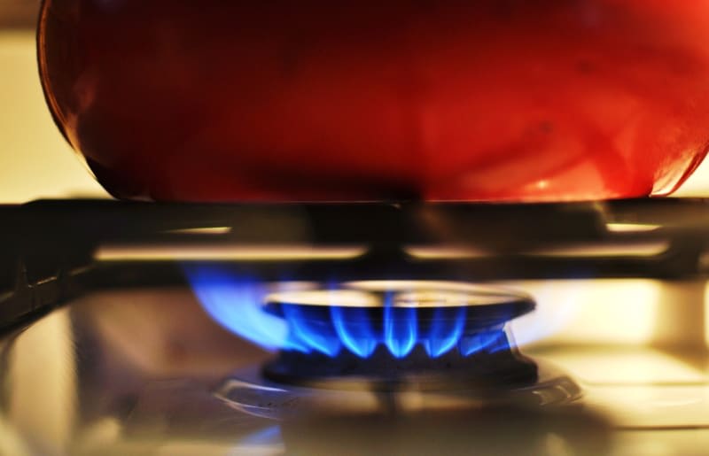 tea kettle on a lit gas stove