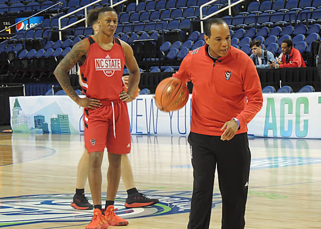 NC State head coach Kevin Keatts runs a drill while fifth-year senior wing C.J. Bryce looks on Tuesday at the Greensboro Coliseum.