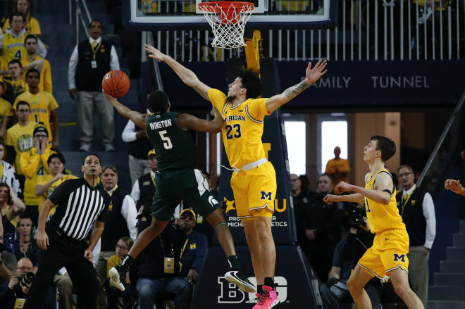 Michigan Wolverines basketball sophomore forward Brandon Johns blocks a shot.