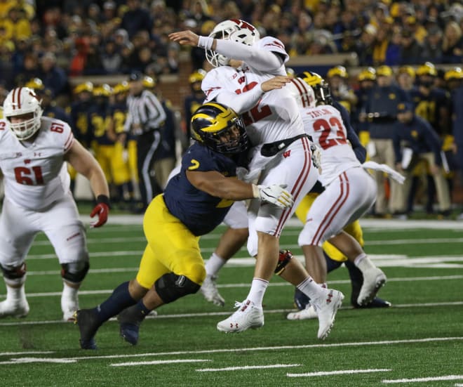 Michigan Wolverines defensive tackle Carlo Kemp hits the Wisconsin Badgers quarterback