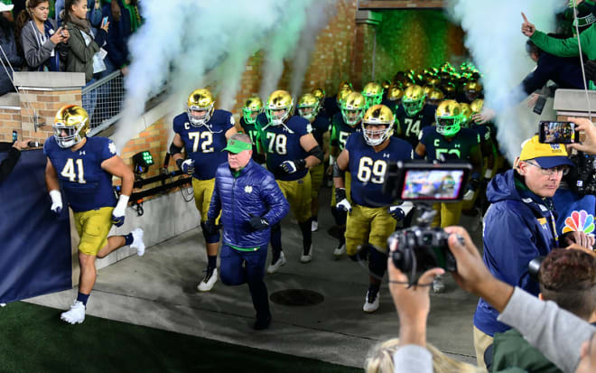 Notre Dame football  players coming out of the tunnel before a game