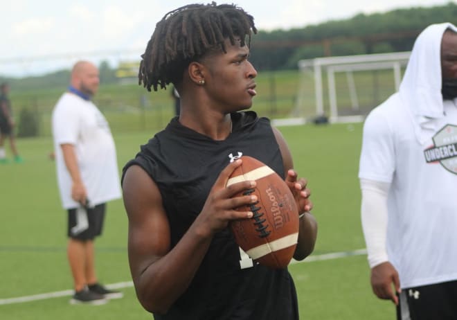 New England quarterback Pop Watson holds a Michigan Wolverines football recruiting offer from Jim Harbaugh.