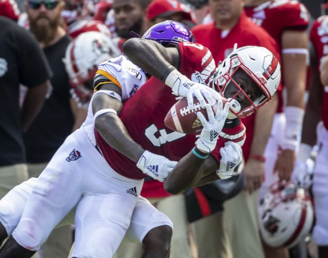 NC State Wolfpack football receiver Emeka Emezie catches a pass.