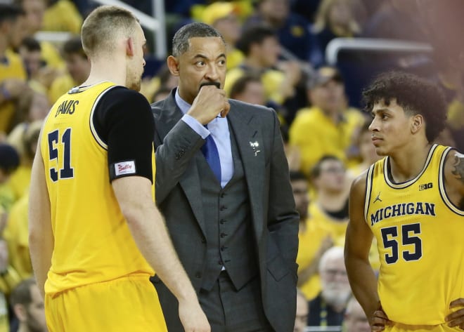 Michigan Wolverines basketball coach Juwan Howard (center)