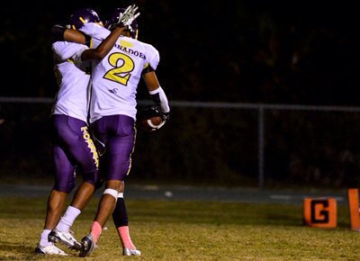 Osirus Mitchell (right) and a teammate celebrate a big play