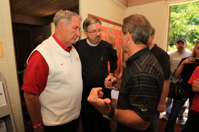 Saban speaks with former Alabama coach Gene Stallings and others on April 28, 2011.