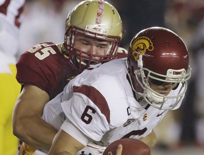 USC QB Cody Kessler (6) is sacked by Boston College LB Christian Lezzer (55) during their game Saturday, Sept. 13, 2014 in Boston.