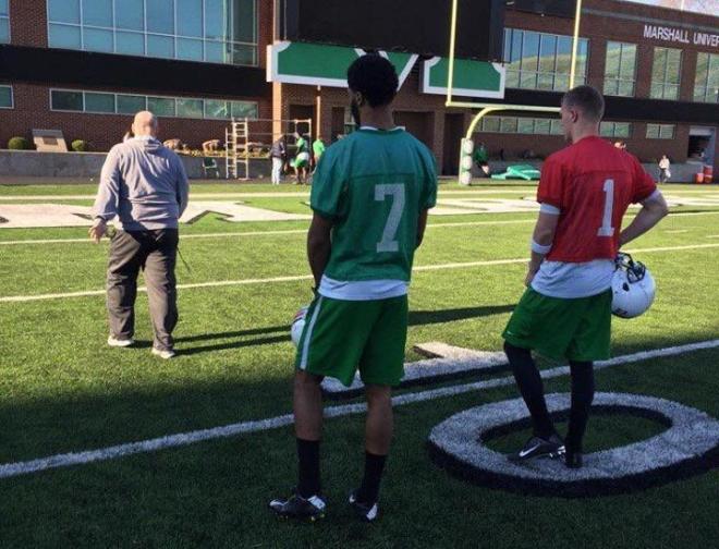 Michael Clark (no. 7) and Chase Litton (no. 1) receive instruction from Coach Bill Legg