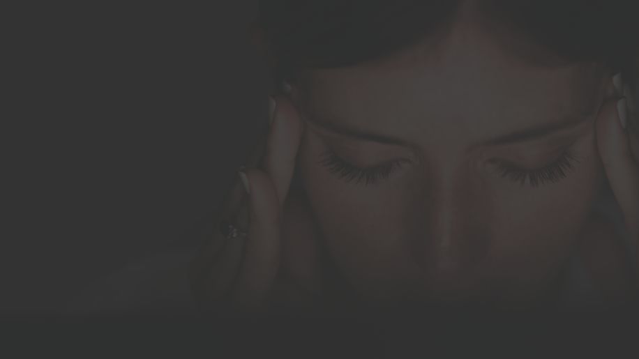 closeup of a woman's holding her temples