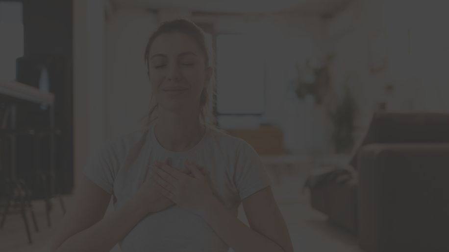 woman eyes closed hands over heart