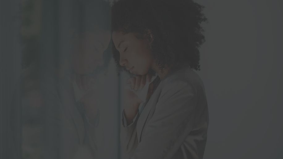 depressed woman pressed against a window