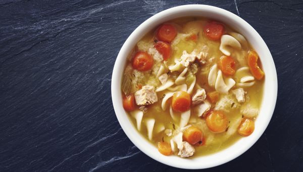 Chicken noodle soup in a white bowl