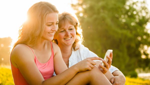 woman with daughter on cell phone