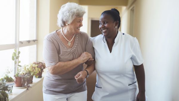 nurse walking elderly patient