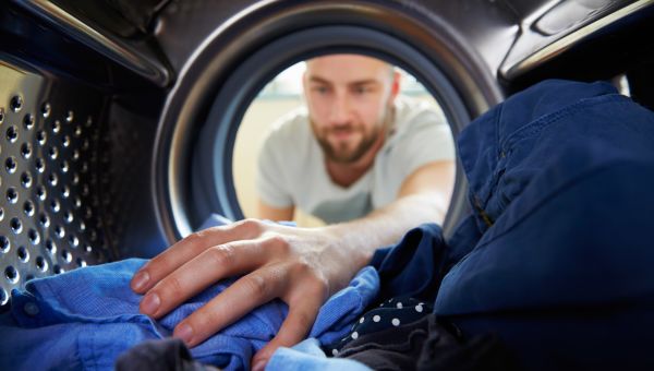 man taking clothes out of the dryer