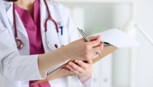 Healthcare provider holding a chart and pen